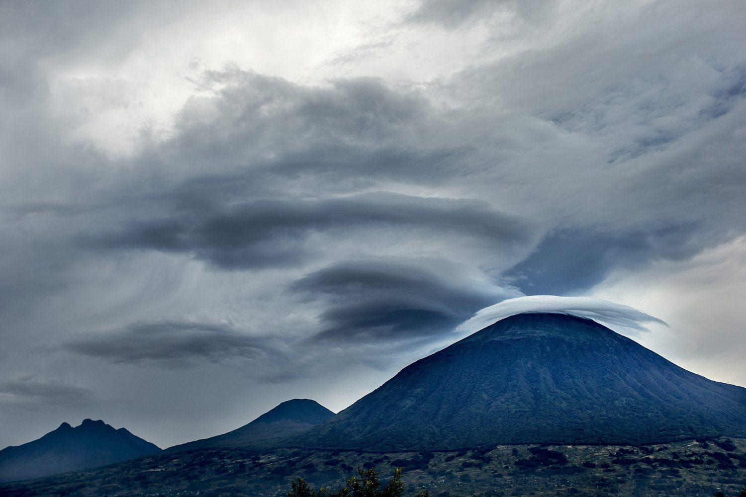 The volcanoes of the Virunga massif towering over farmland in northern Rwanda