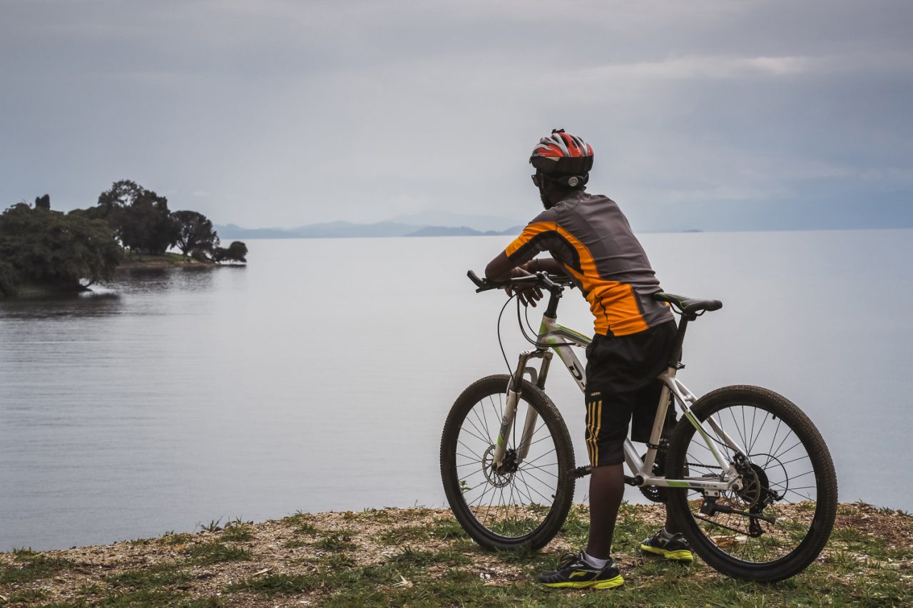 A cyclist on the Congo Nile Trail above Lake Kivu